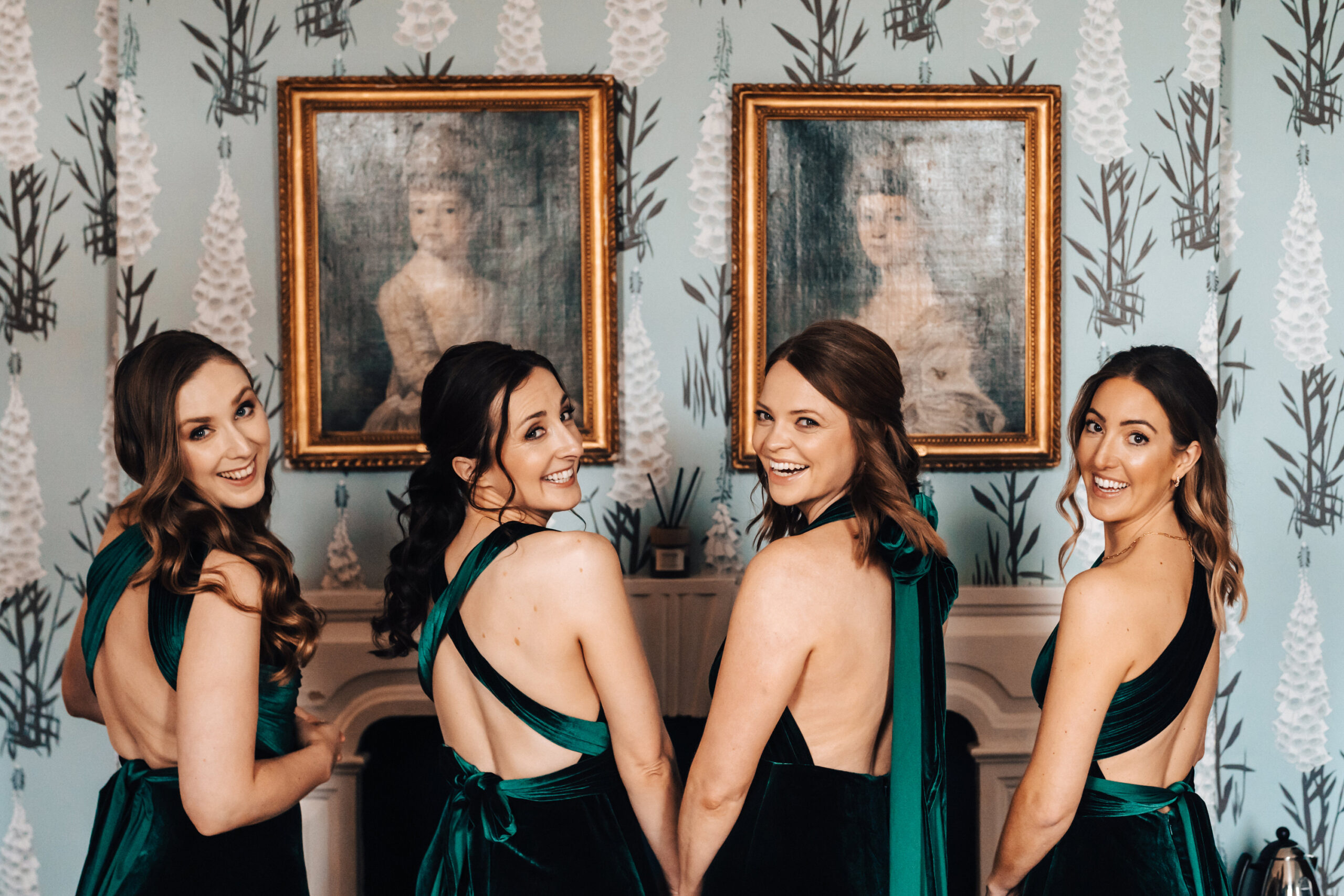 Four girls wearing green silk bridesmaid dresses