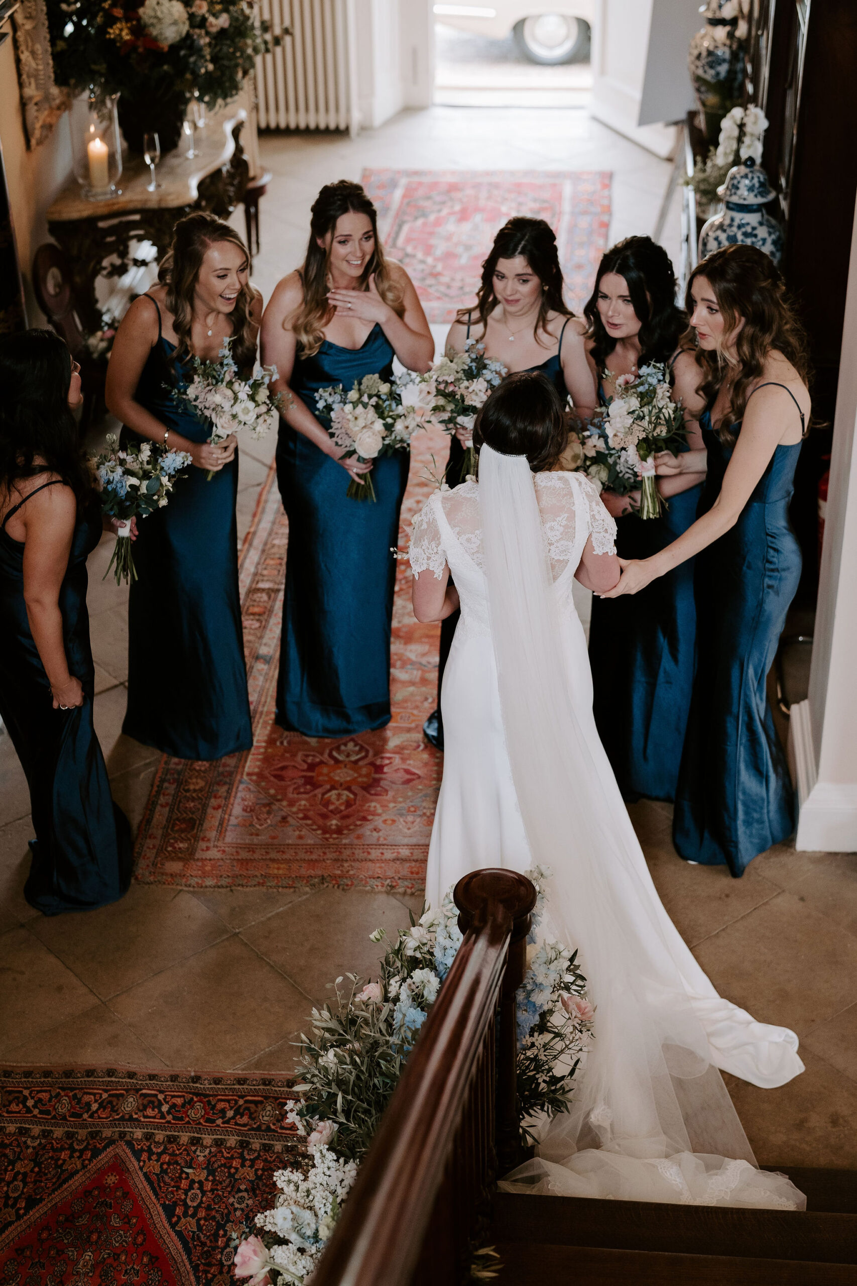 A view looking down onto a bride and her six bridesmaids gathering around her