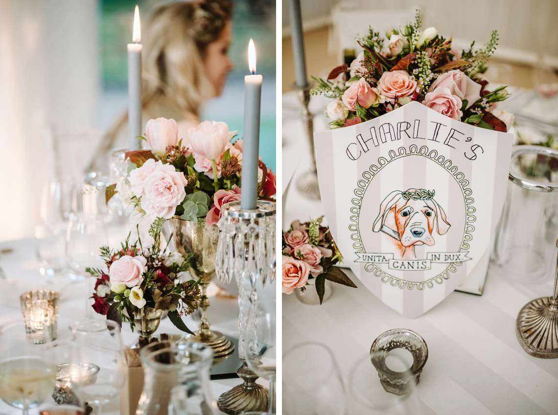 Floral arrangements using lots of roses in a range of pink and berry shades sit in silver cups and chalices on a wedding table