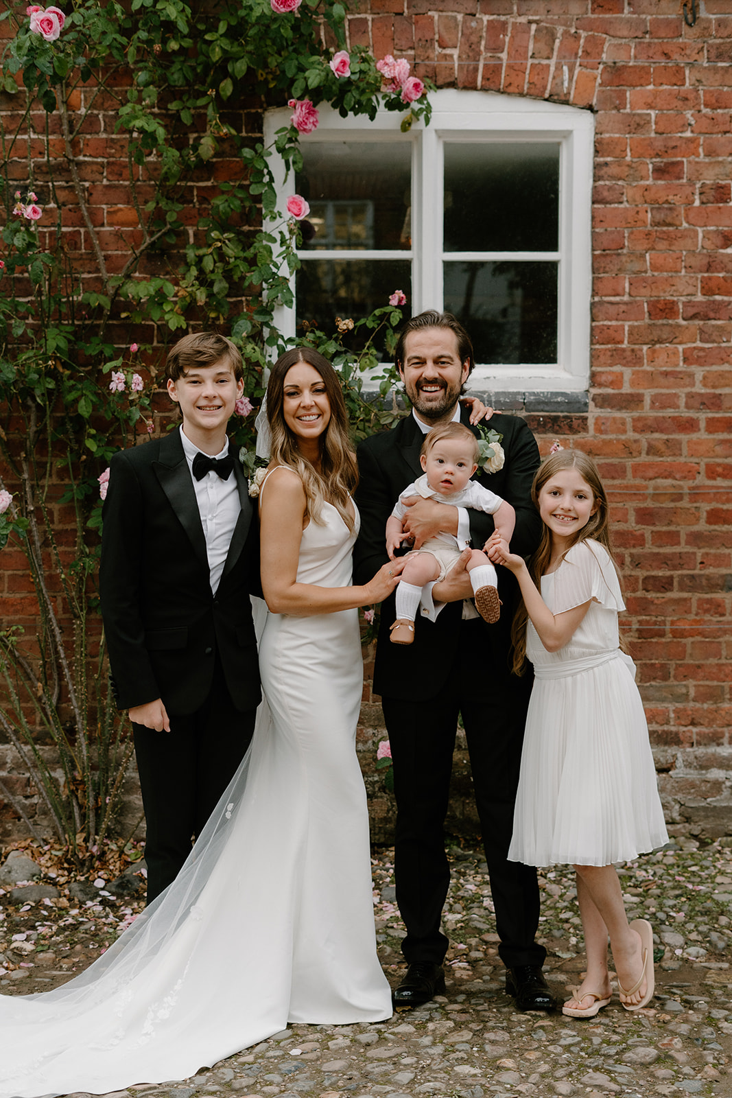 A quintessentially English summer wedding at luxury wedding venue Iscoyd Park with a green, black and white colour scheme, black tie and two wedding dresses photographed by Rebecca Kerr Photography.