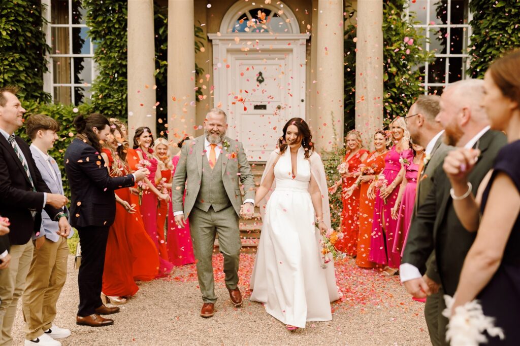 Hot pink and bright red colour pop outdoor civil ceremony Summer Pigeon House wedding at Iscoyd Park by Harry Michael Photography