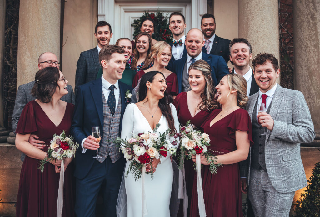 Winter Christmas wedding at Iscoyd Park with deep red bridesmaids dresses and long sleeved bridal gown by Inverve Photography